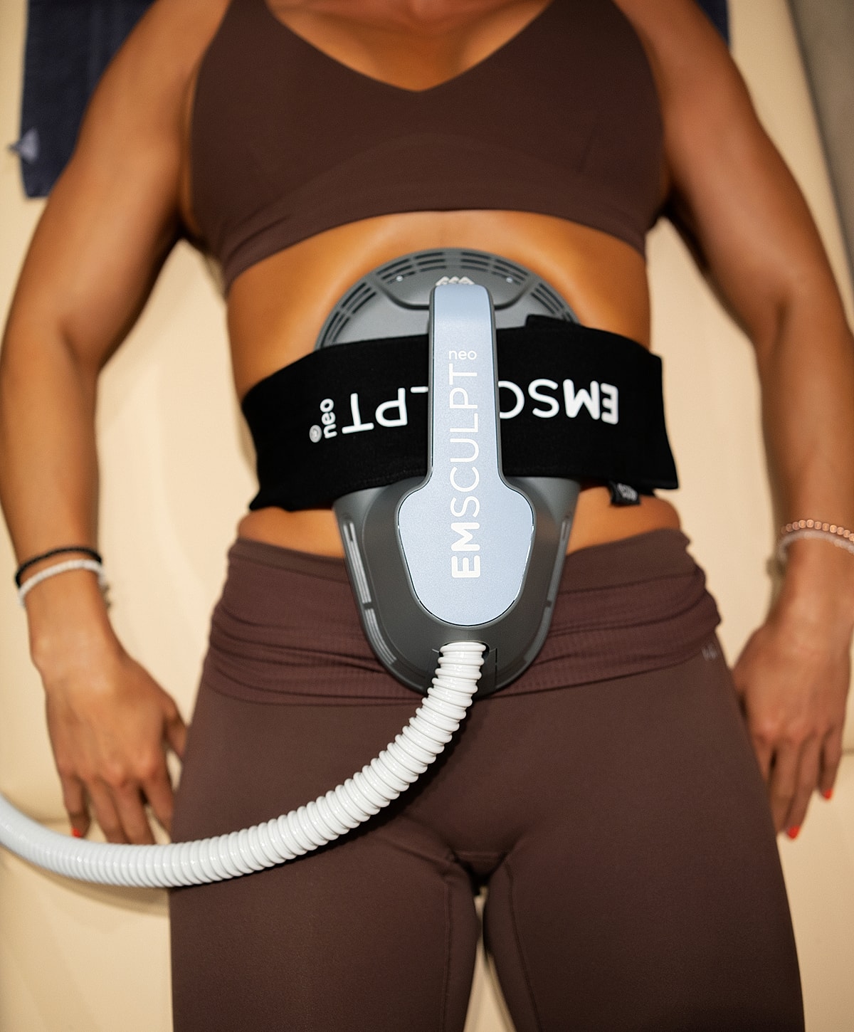 Emsculpt Neo treatment on a person's abdomen.