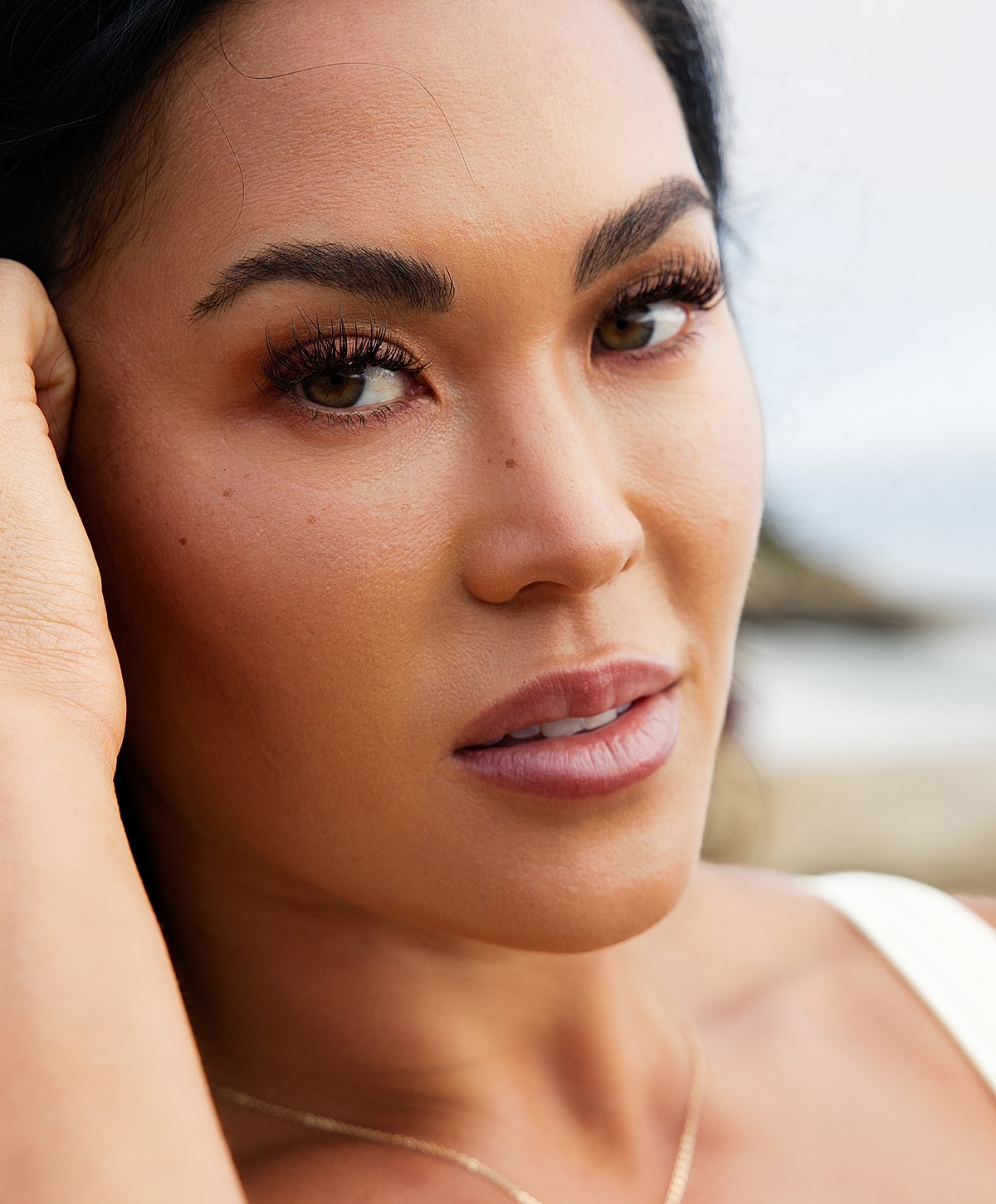 Close-up portrait of a woman outdoors.