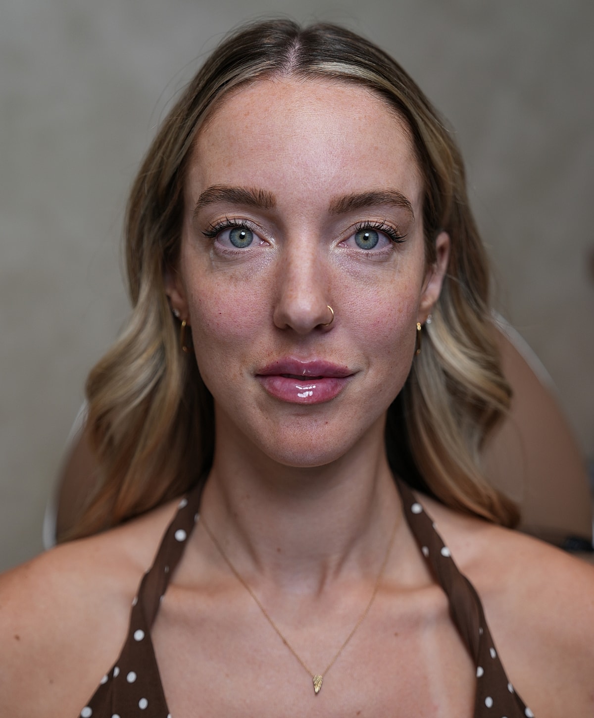 Woman with blonde hair and green eyes.