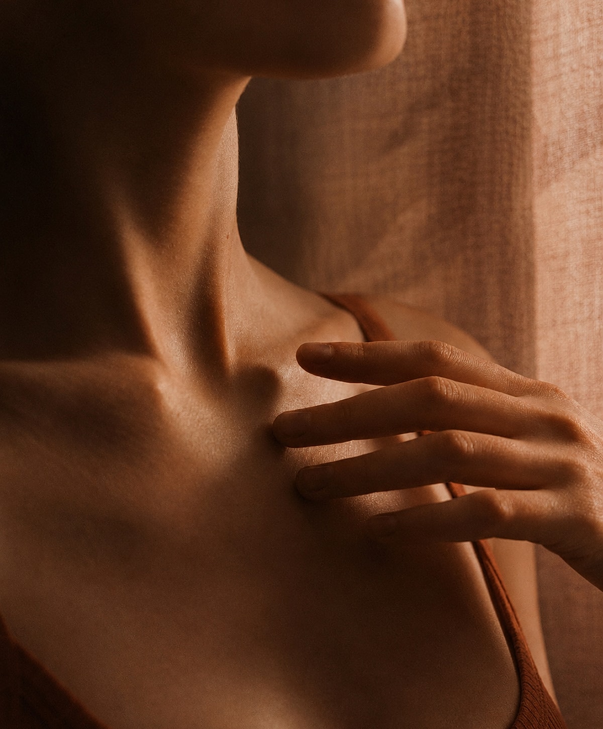 Close-up of a person's neck and hand.