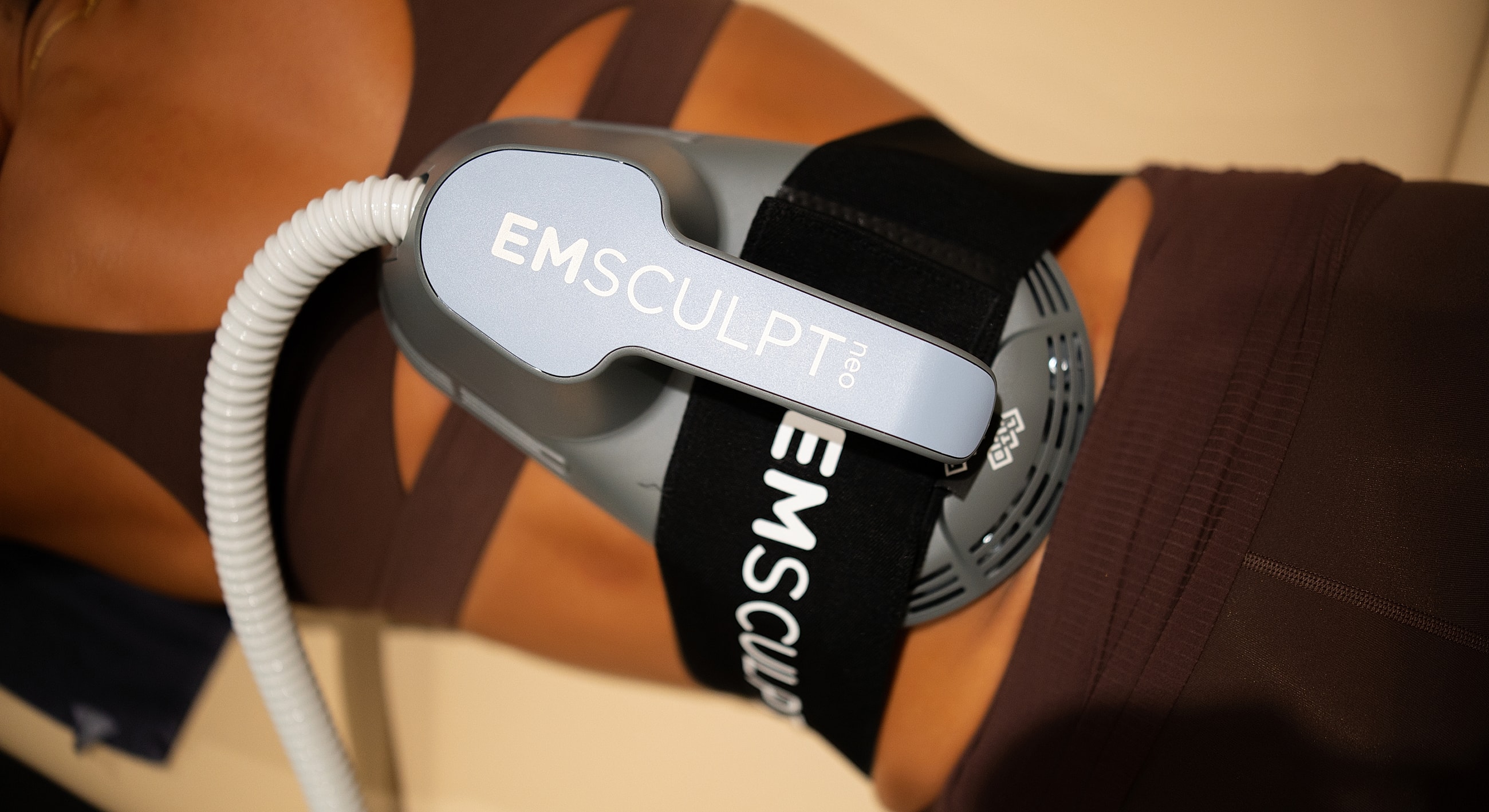 EMSCULPT device on a person’s abdomen.