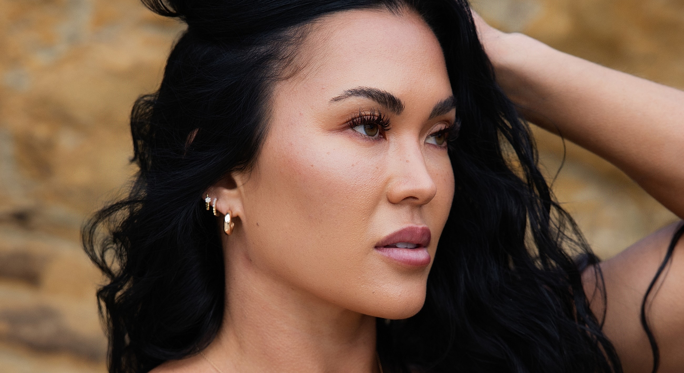Woman with long dark hair in profile.